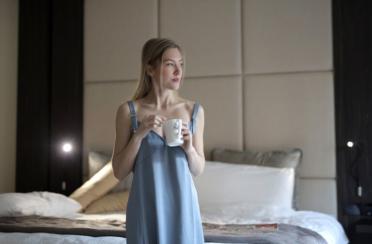 Woman in nightie holding a mug